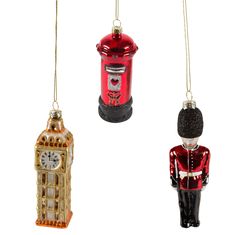 three christmas ornaments in the shape of london and big ben hanging from chains on a white background