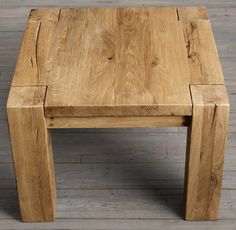 a wooden table sitting on top of a hard wood floor