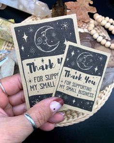 a person holding up two small cards with the words thank you for suppling my small business