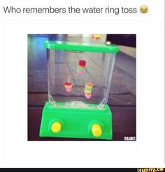 a toy machine with candy in it sitting on the ground next to a sign that says, who remembers the water ring toss?