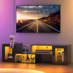 a living room with a large flat screen tv mounted on the wall above it's entertainment center