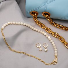 Our fine Mother of Pearl Necklace with gold-filled chain is a graceful and elegant piece that seamlessly blends sophistication with a touch of sparkle. This necklace features lustrous half mother of pearl complemented by a half fine gold-filled chain. The front hook, adorned with a glistening rhinestone, not only adds a hint of glamour but also serves as a stylish closure. The delicate design ensures that this necklace can effortlessly elevate both casual and formal ensembles. The combination of White Pearl Jewelry With Gold Chain, Classic Gold Necklace With Mother Of Pearl, Elegant Gold-tone Pearl Necklace With Adjustable Chain, Chic Gold Mother Of Pearl Jewelry, Elegant 14k Gold-filled Chain Necklace With Lobster Clasp, Pearl Chain Necklace With Lobster Clasp As Gift, Gold Mother Of Pearl Necklace For Gift, White Delicate Chain Necklace In Gold Plated, Gold Pearl Necklace For Everyday Feminine Style