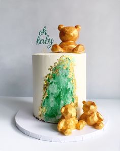 there is a white cake with gold bears on it