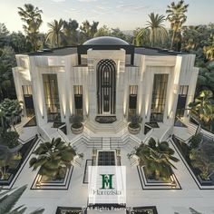 an aerial view of a building with palm trees in the foreground