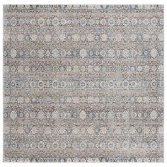 an area rug with different colors and patterns on the floor, including grays, browns, and blue