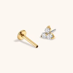 two diamond studs in yellow gold on a white background