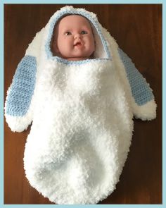 If only this was touch-o-vision!!  This super adorable crocheted baby bunny hooded cocoon is made with super soft Bernat Pipsqueak yarn.  Your baby will be so snuggly comfy he will never want out of this sweet cocoon. This baby bunny hooded swaddle cocoon fits baby 0-3 months old.  The extra long soft ears are made with Bernat Pipsqueak yarn as well and have a hand sewn blue or pink inner ear.  On the back, there is an adorable faux fur fluffy tail that easily removes with a snap so that the cocoon can be washed.  Baby easily slips in and out of the face hole. Think of the incredible pictures of your sweet little bunny!  Makes a great new baby or baby shower gift. Free shipping. An original TreasuresbyJacquie design. Bernat Blanket Yarn Patterns Crochet Baby Cocoon, Crochet Baby Shark Cocoon Free Pattern, Baby Sleep Sack Pattern Free Crochet, Baby Boy Baby Shower Gift, Bunny Photo, Baby Dolls For Toddlers, Boy Baby Shower Gift, Elephant Blanket, Doll Carrier