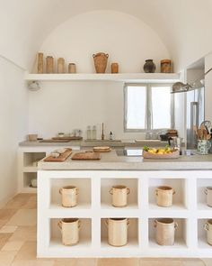 the kitchen is clean and ready to be used for cooking or baking, with many pots on the counter