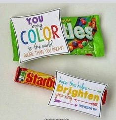 two candy bars with colorful labels on them sitting next to each other and one has a note that says you bring color to the world more than you know