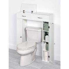 a white toilet sitting under a bathroom cabinet