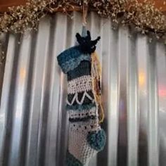 a crocheted stocking hanging on a metal wall