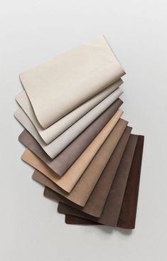 six different colors of fabric on top of each other, with one folded in the middle