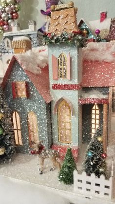 a toy house with christmas trees and decorations