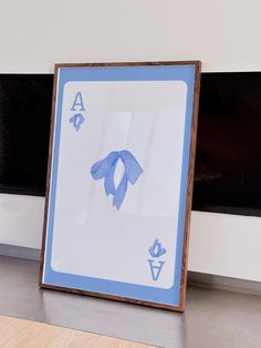 a blue and white ace playing card sitting in front of a window