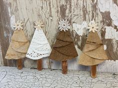 three small wooden christmas trees sitting next to each other