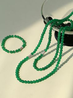 This elastic necklace combines traditional Chinese aesthetic elements with modern style. Featuring sparkling zirconia beads and soothing green agate beads, this necklace exudes elegance and sophistication. The intricate bead arrangement creates a harmonious balance between vintage charm and modern style. Metal: Recycled Sterling Silver Gemstone: Cubic Zirconia,Green Onyx Diameter: Long 760mm,Short 440mm Weight: Long 42g,Short 24g Elegant Green Jade Crystal Necklace, Elegant Jade Crystal Necklaces With Round Beads, Elegant Beaded Jade Crystal Necklaces, Elegant Jade Crystal Necklace With Round Beads, Elegant Beaded Jade Crystal Necklace, Elegant Jade Jewelry With Spacer Beads, Elegant Green Bracelets With Silver Beads, Elegant Green Beaded Necklaces With Polished Beads, Elegant Green Crystal Necklaces With Polished Beads