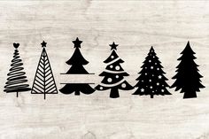 the silhouettes of christmas trees are shown in black and white on a wood background