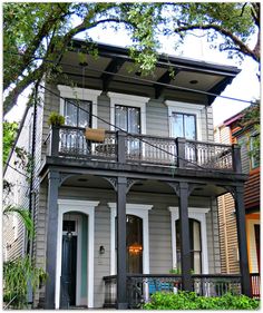 the front of a two story house with balconies