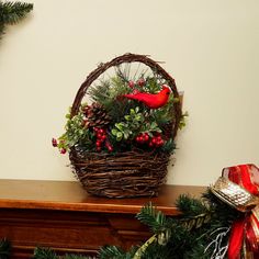 a basket filled with pine cones and red birds sitting on top of a wooden table