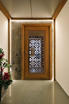 a wooden door with decorative glass on the side