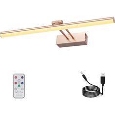 a desk lamp with remote control and charger next to the light on the wall