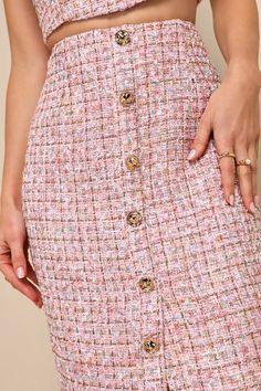 Get ready to set trends wherever you go in the Lulus Charming Icon Pink Tweed Lurex Button-Front Midi Skirt! Woven tweed fabric boasts sparkling, multicolored Lurex as it shapes a high waist and a pencil-style skirt. Button placket boasts half-and-half design, with decorative buttons at the top and a flirty unbuttoned effect at the hem. Hidden zipper/clasp at back. Pair with the matching top for a complete look! Fit: This garment fits true to size. Length: Mid-calf length. Size medium measures 2 Pink Workwear Skirt With Buttons, Pink Buttoned Workwear Skirt, Pink Buttoned Skirt For Work, Tweed Skirt With Button Closure For Workwear, Pink Fitted Tweed Dress, Fitted Tweed Skirt With Buttons, Chic Pink Tweed Skirt, Chic Tweed Skirt With Button Closure, Pink Chanel Tweed