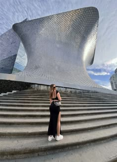 a woman is taking a selfie in front of stairs