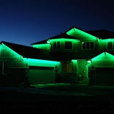 a house is lit up with green lights