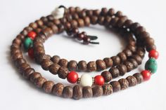 This is a Indian Bodhi Seed Mala with dark brown color Side cut.Its has been decorate with Naga shell and Red coral Beads. Handmade in Nepal. 11mm 108 beads 24inch long Necklace. Meditation Buddha Shop For Nepali handmade Products. We Supports Small Family Artisans who create a Beautiful handmade rituals Products. Handmade Brown Beaded Bracelets For Ceremonial Use, Handmade Brown Beaded Bracelets For Rituals, Traditional Brown Beaded Bracelets For Festival, Traditional Brown Beaded Bracelets For Rituals, Traditional Brown Mala For Rituals, Traditional Handmade Brown Beaded Bracelets, Traditional Brown Beaded Bracelets As Gift, Brown Bohemian Mala With 108 Beads, Bohemian Brown Mala With 108 Beads