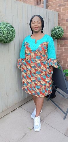 Ankara midi shift dress with beautifully intricate lace detailing is gorgeous and on trend with fitted to puff sleeve. Perfect for informal events, get to together when you simply need to make an effortless statement!  Unlined Colour: multi - colour Fit: loosely shaped Sleeve: fitted regular Pocket: two side pockets Length: knee African print  CARE INSTRUCTIONS: Hand wash cold. DO NOT BLEACH. Hang dry. Press with cool iron on the wrong side only. Colour may vary slightly due to lighting. Long Sleeve Lace Dress With Patchwork, Casual Green Dress With Lace Patchwork, Patchwork Shift Midi Dress, Knee-length Printed Shift Dress, Elegant Patchwork Shift Dress, Printed Shift Dress, Knee-length, Elegant Shift Dress With Patchwork, Summer Sheath Dress With Lace Sleeves, Patterned Knee-length Mini Dress