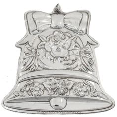 a metal bell with a flower design on it