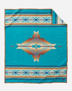 a blue blanket with an orange and white design on the front, and a turquoise background