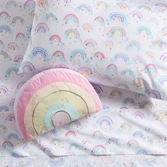 a bed with rainbows and stars on it