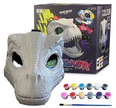 the dinosaur mask is next to some paint