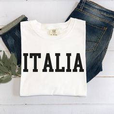 Italia T-shirt Italian Tee Comfort Colors T-shirt Gift for Italian Italy Tee Shirt Italian Apparel Unisex T-shirt Italia Tee DETAIL: Comfort Colors introduces its garment-dyed t-shirt; a fully customizable tee made 100% with ring-spun cotton. The soft-washed, garment-dyed fabric brings extra coziness to your wardrobe while the relaxed fit makes it an excellent daily choice. The double-needle stitching throughout the tee makes it highly durable while the lack of side-seams helps the shirt retain its tubular shape. .: Made with medium fabric (6.1 oz/yd² (206.8 g/m consiting of high quality, 100% ring-spun US cotton for long-lasting comfort. All shirts feature pre-shrunk cotton for size retention and a signature twill label.  .: The relaxed fit keeps the wearer comfy in both casual and semi-f White Print Text Crew Neck T-shirt, White Print Crew Neck Shirt With Letter Print, White Print Crew Neck Shirt With Logo, Basic Crew Neck T-shirt With Letter Print, Basic Crew Neck T-shirt With Slogan, Basic Crew Neck Shirt With Slogan, Italian Outfits, Dyed Fabric, Dye T Shirt