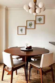 a dining room table with four chairs around it