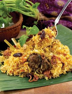 a close up of a plate of food with rice and meat on it next to other foods