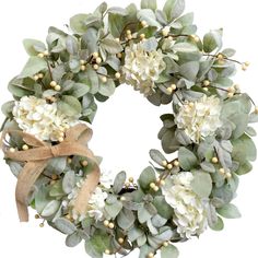 a wreath with white flowers and green leaves