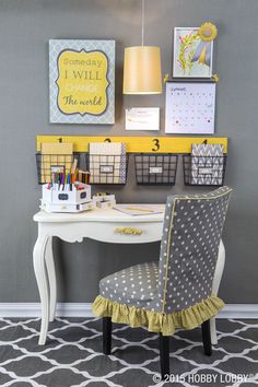 a desk with a chair and some pictures on the wall