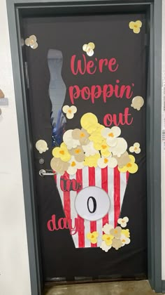 a door decorated with popcorn and the words we're poppin'out