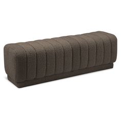 a large brown bench cushion sitting on top of a white floor