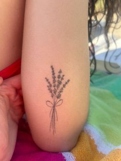 a woman's leg with a tattoo on it that has lavenders growing out of it