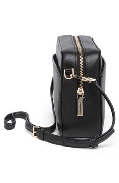 Made of smooth calfskin leather, this crossbody camera bag features zip closure to securely store your camera to easily capture all your favorite moments. 5.75" H x 8.5" W x 2.5" D; 22" strap drop length Removable, adjustable crossbody strap Top zip closure Leather Imported Chic Camera Shoulder Bag With Zipper Closure, Elegant Travel Camera Bag With Zipper Closure, Chic Travel Camera Bag With Zipper Closure, Classic Everyday Camera Bag With Zipper Closure, Classic Camera Bag With Zipper Closure For Everyday, Classic Rectangular Camera Bag With Zipper Closure, Modern Crossbody Camera Bag With Zipper Closure, Chic Rectangular Camera Bag With Cell Phone Pocket, Rectangular Camera Bag With Zipper Closure For Business