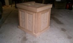 a wooden box sitting on the ground in a garage