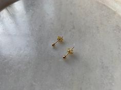 Small ball studs in 18k gold plated on 925 sterling silver also avalaible in 925 ss, nickel free. The diameter of this studs is 2.5 mm. Push back closure. Sold in pairs. Easy and confortable to wear. Beatiful and nice to combine with other dainty studs or hoops at the same ear. Is a perfect choice for you outfit of the day. Click here to visit my shop: www.etsy.com/shop/candelajoies and see plenty more dainty little pieces. All our products come inside a cotton bag or small gift box, ready for g Dainty Studs, Small Gift Boxes, Studs Earrings, Letter Necklace, Small Gift, Gold Studs, Cotton Bag, I Shop, 18k Gold