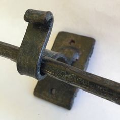 an old metal door handle on a white wall