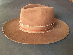 "Firm wide brim brown felt Fedora Cowboy Hat ... bohemian / hippie style... purchased at Abiquiu Inn / Georgia O'keefe welcome center, Abiquiu, New Mexico...  in excellent like new condition, worn only once... Western / Southwestern Nomad... with leather & frayed band finish... large, 59cm From hat maker's listing (along with the last 3 photos) : This Felt Fedora Hat is the rancher style hat of your dreams. Featuring a frayed texture band with a leather accent strip and a wide brim, it is guaran Brown Felt Hat With Flat Crown For Fall, Rustic Brown Fedora With Curved Brim, Brown Leather Hats For Festivals, Western Brown Fedora With Flat Crown, Western Style Brown Fedora With Flat Crown, Brown Fedora With Flat Crown For Ranch, Brown Fur Felt Hat Band For Ranch, Rustic Brown Brimmed Fedora, Brown Felt Hat For Rodeo In Fall