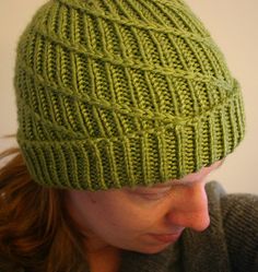 a woman wearing a green knitted hat