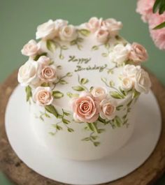 a white cake with pink flowers on it