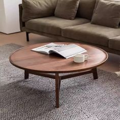 a coffee table sitting on top of a carpeted floor next to a brown couch